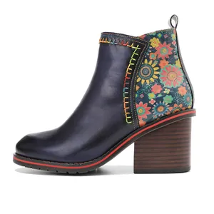 Vintage-style genuine leather ankle boot featuring floral patchwork and a thick wooden heel.