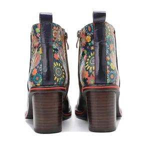 Detailed back view of vintage floral leather ankle boots with chunky wood grain heels.