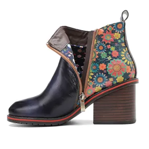 Side view detail of retro patchwork leather ankle boots with vibrant floral patterns