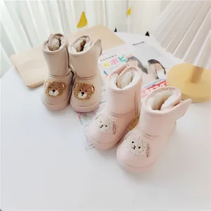 Warm cartoon children snow boots with cute bear and dog patches and velcro straps.