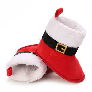 Detail view of red Santa-themed baby snow boots with fluffy white fur trim