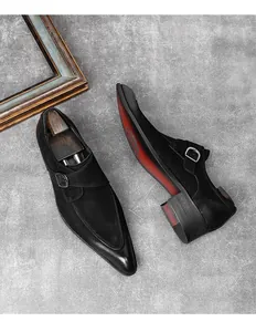 Men's black pointed toe monk strap dress shoes featuring a red sole and suede finish