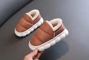 Close-up of warm plush lining and waterproof leather upper on toddler winter snow boots