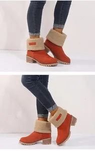 Detailed view of women's orange suede snow boots with sherpa lining and chunky mid-heel design