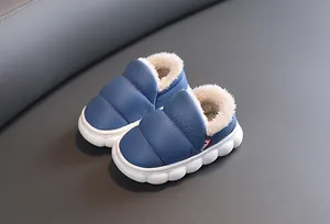 Detail view of waterproof blue toddler snow boots featuring thick white faux fur lining