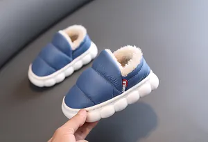 Close-up detail of kids blue fleece-lined waterproof snow boots with a thick white sole