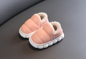 Detailed shot of pink puffer-style children's winter shoes featuring warm white fleece lining