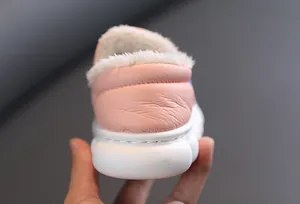 Detail view of pink winter boots for kids showing thick plush lining and soft leather