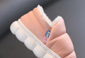 Macro detail view of pink children's winter snow boot with soft white faux fur lining