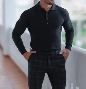 Detail of black ribbed long-sleeve polo shirt with muscle fit and button placket.