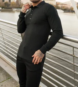 Close-up of a men's black ribbed long-sleeve polo shirt with vertical stripes.