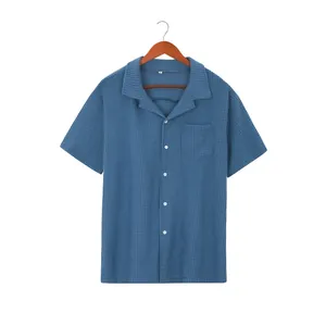 Close-up view of a blue waffle knit texture on a men's short sleeve button down shirt