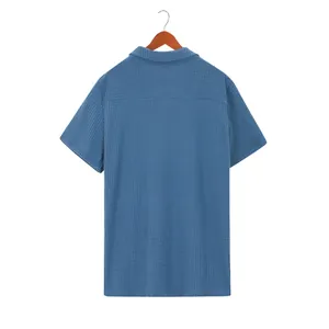 Detailed back view of a men's blue waffle-knit short-sleeved polo shirt on a wooden hanger