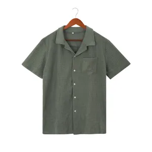 Detailed view of a green waffle-knit men's short-sleeve shirt with lapel collar