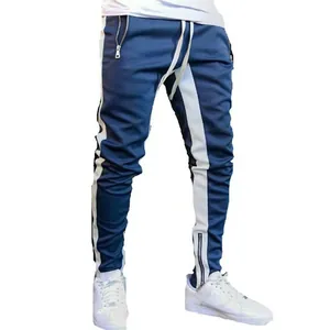Men's slim fit blue joggers with side white stripes and functional ankle zippers