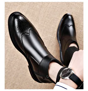 Close-up of black brogue Chelsea boots for men with side zipper and wingtip detail