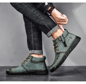 Close-up detail of men's teal mid-cut Martin boots featuring a side zipper and rugged sole