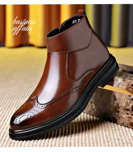 Detail view of brown leather Chelsea boot with Brogue wingtip carvings and zipper.