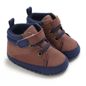 Detail of brown and navy high-top baby walking shoes with soft non-slip canvas soles