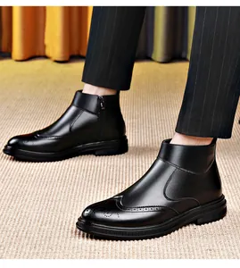 Detail view of black leather Brogue Chelsea boots with pointed toe and side zipper