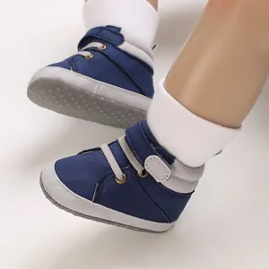 Close-up of navy blue high-top infant walking shoes with anti-slip rubber dot sole