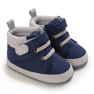 Detail view of navy blue high-top canvas baby walking shoes with flexible soft soles