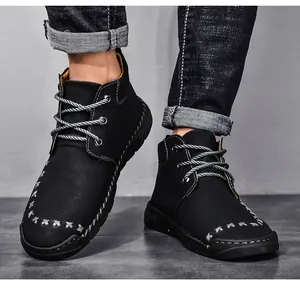 Detailed view of black mid-top Martin boots with unique hand-stitched toe design.