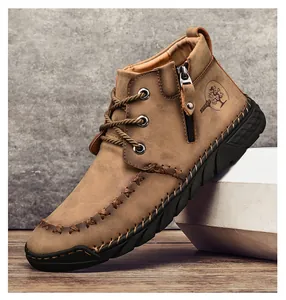 Close-up of brown men's Martin boots featuring a side zipper and cross stitching