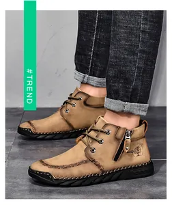 Detailed view of men's khaki mid-top work boots with side zipper and rugged outsole.