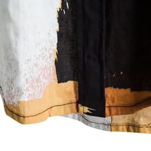 Close-up of men's casual beach shirt hem showing abstract patchwork linen texture