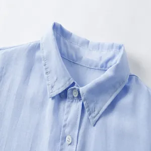 Close-up detail of a light blue Oxford long sleeve shirt collar showing fabric texture