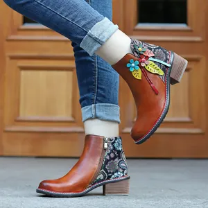Primer plano de botines de cuero vintage hechos a mano con detalles de flores 3D de colores