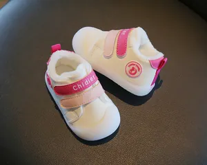 Fleece-lined baby walking shoes with pink velcro straps and soft non-slip soles