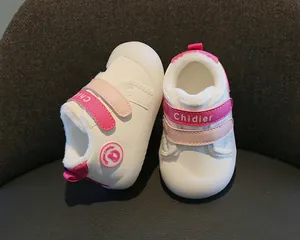 Detailed view of warm winter baby walking shoes with soft pink plush lining.