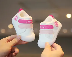 Close-up of white baby walking shoes with warm fleece lining and pink straps