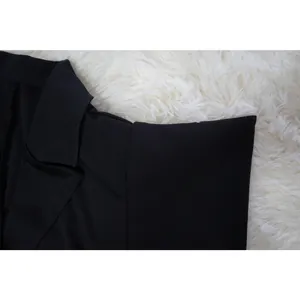 Detailed macro view showing the classic black blazer-style collar on a women's dress.