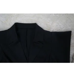 Close-up detail of the classic notched lapel collar on a black plus size women's dress