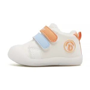 Comfortable white baby walking shoes with orange and blue velcro straps and soft sole