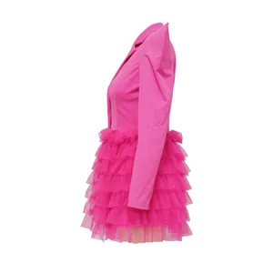 Side view of a hot pink autumn blazer dress with a layered ruffled tulle cake skirt detail.