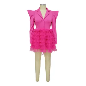 Close-up detail of hot pink blazer dress featuring layered tulle ruffled cake skirt