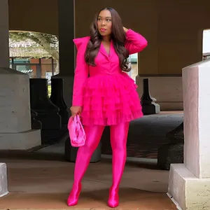 Vibrant hot pink tiered ruffle mini dress for women shown in a street style setting.