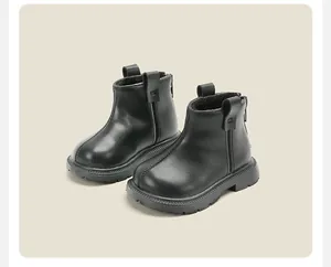 Detail shot of stylish black baby winter boots with thick soles and back zipper.