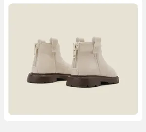 Detailed back view of cream baby Martin boots with rear zipper and thick brown soles