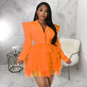 Stylish women's orange blazer dress with tiered ruffled tulle skirt and peaked lapels.