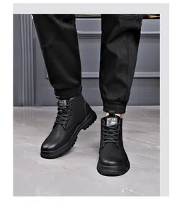 Close-up of stylish black lace-up leather Martin boots worn with black trousers
