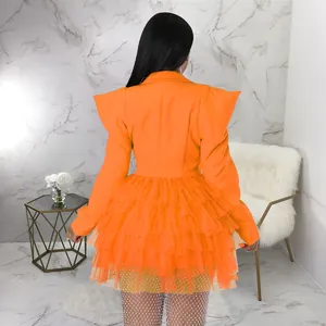 Rear view of vibrant orange blazer dress featuring layered tulle ruffle cake skirt