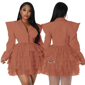 Detail view of a terracotta tiered mesh blazer dress with exaggerated shoulders.