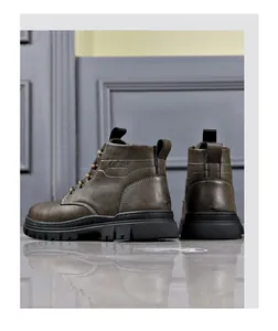 Rear view of brown leather Martin boots with thick black soles and lace-up design