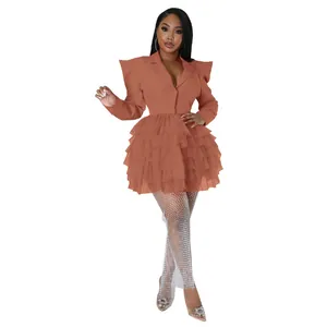 Full length view of a terracotta blazer mini dress featuring a tiered ruffle cake skirt