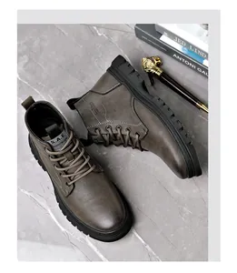 Detailed overhead view of premium brown lace-up leather Martin boots on grey marble background